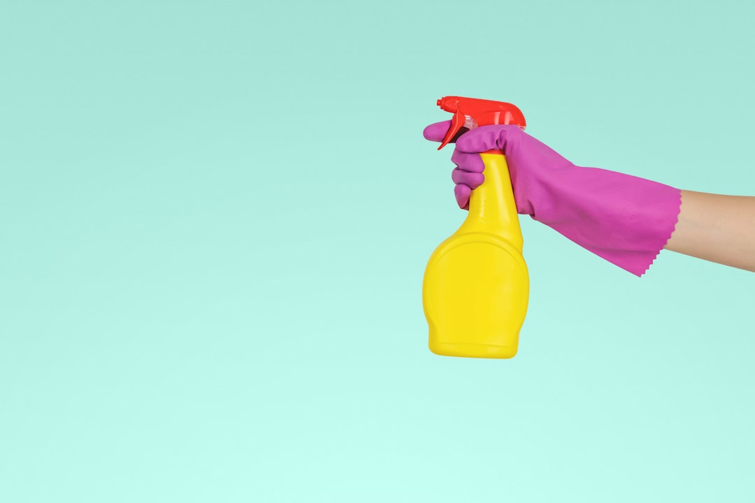 home-services-03 person-holding-yellow-plastic-spray-bottle-zmnefoi3k